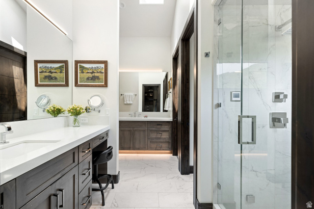 11547 Soaring Hawk Lane Hideout, UT 84036 - Photo 8 of 43 Spacious bathroom featuring a glass-enclosed shower with tile surround, double vanity with integrated sinks, wood-finish cabinetry, and recessed lighting