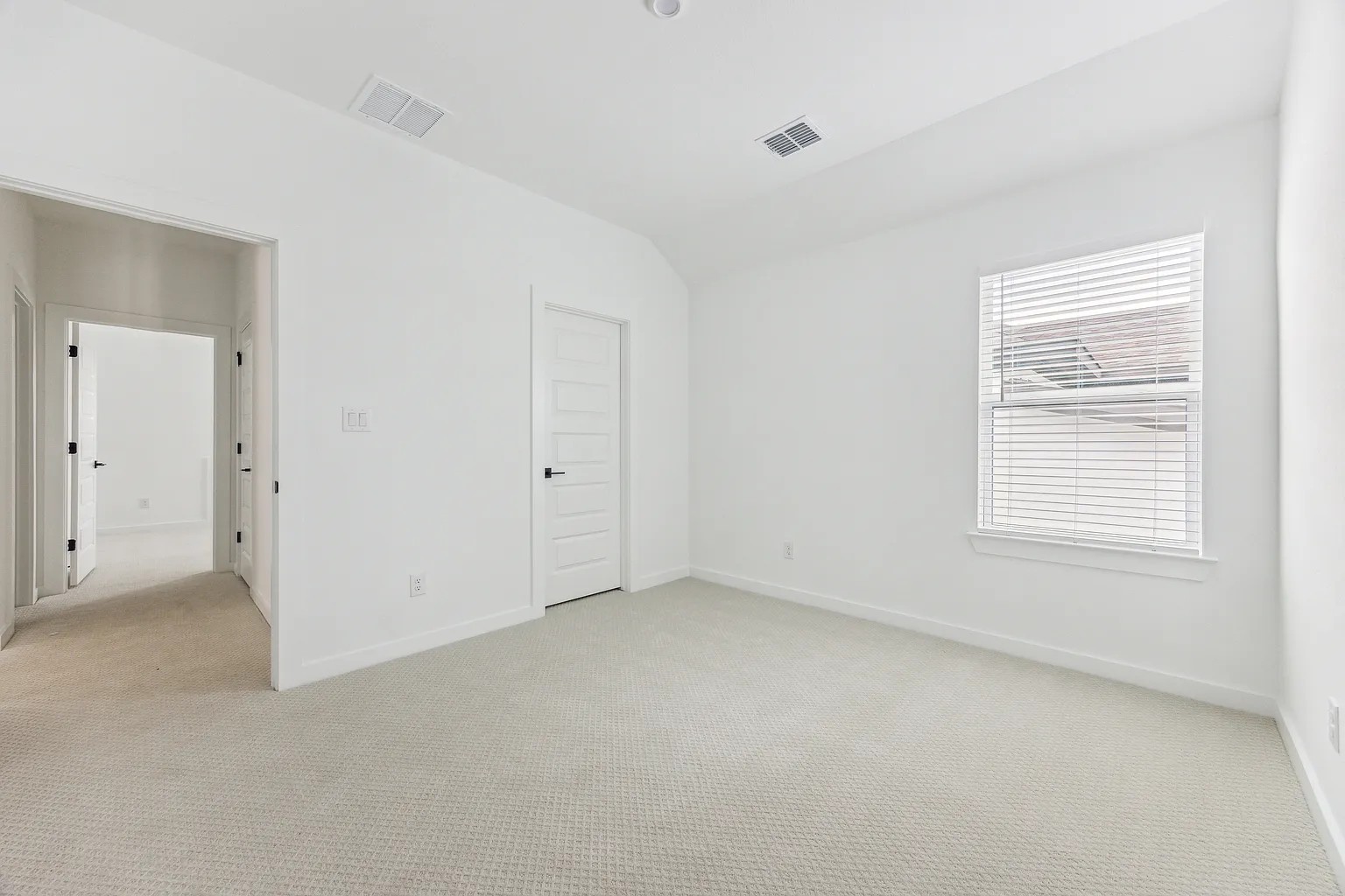 1909 Varese Path Leander, TX 78641 - Photo 34 of 40 A spacious, naturally illuminated room featuring plush carpeting and a neutral palette.