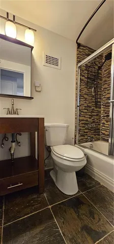 a bathroom with a toilet and a shower
