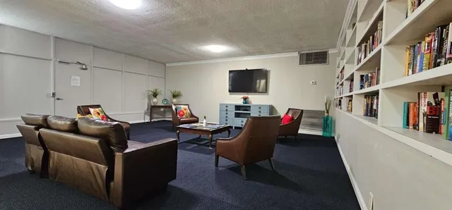 a living room with furniture and a flat screen tv