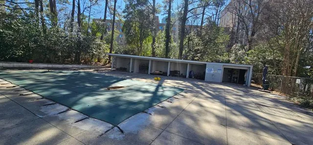 a view of a house with backyard and trees