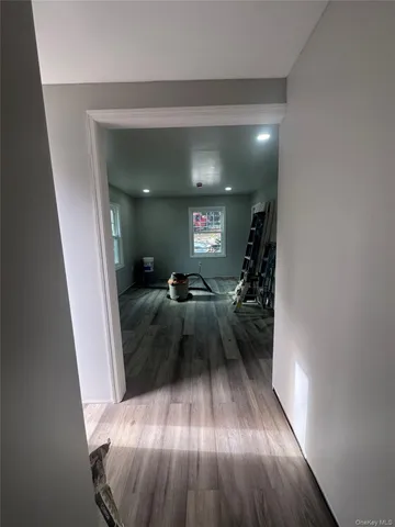 a view of entryway and hall with wooden floor