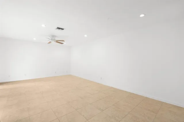 a kitchen with stainless steel appliances granite countertop a refrigerator sink and white cabinets