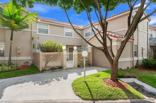 a view of a house with a yard and garage