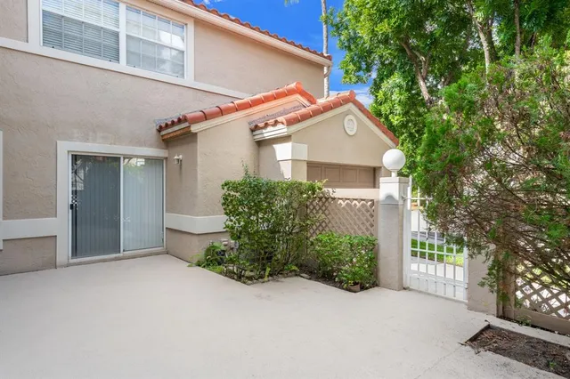 a view of a room with sliding windows and a chandelier fan