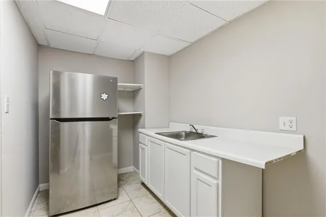 a kitchen with stainless steel appliances granite countertop a refrigerator a sink and a stove