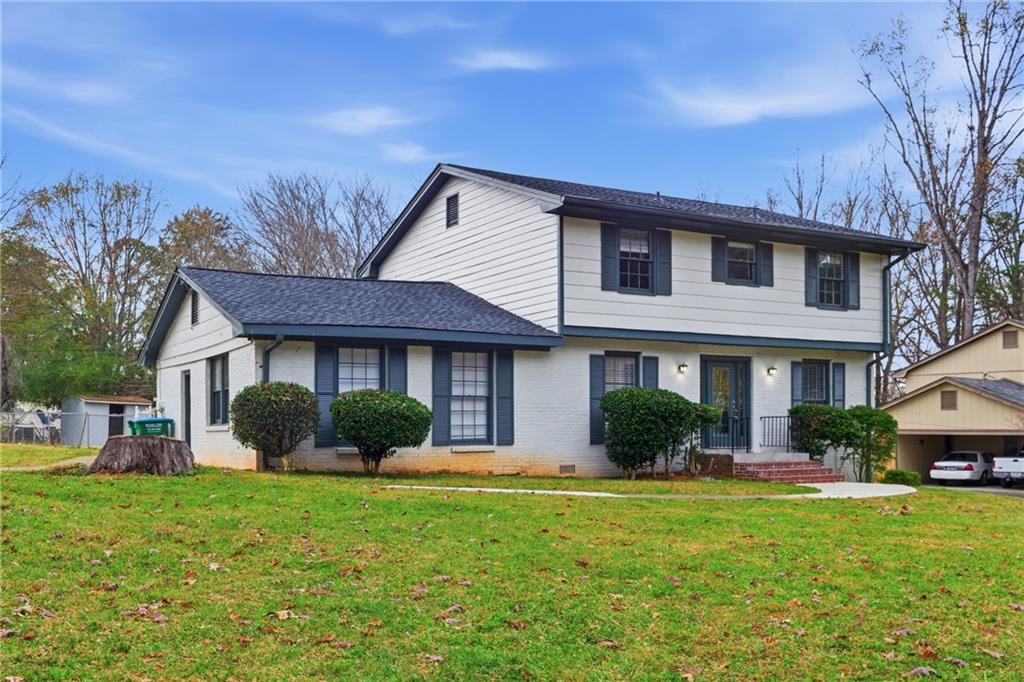 127 Old Rosser Road Lilburn, GA 30047 - Photo 2 of 34 a front view of a house with a yard