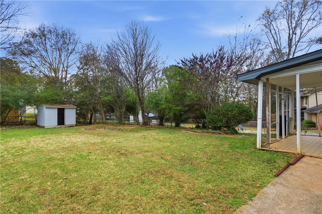 127 Old Rosser Road Lilburn, GA 30047 - Photo 24 of 34 a yellow house with trees in front of it