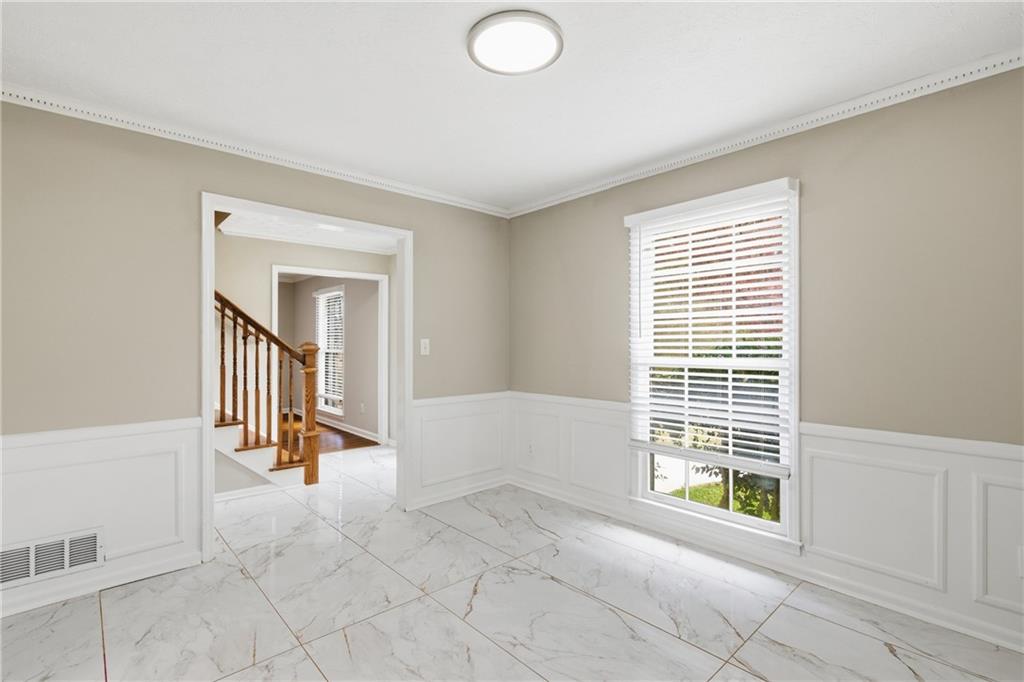127 Old Rosser Road Lilburn, GA 30047 - Photo 4 of 34 a view of an empty room with a window