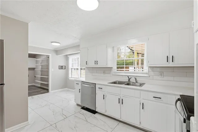 a kitchen with a sink cabinets and window