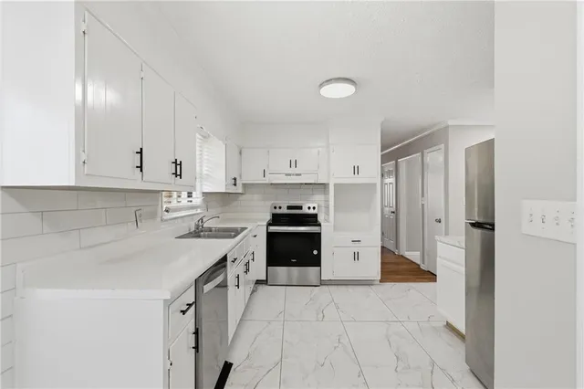 a kitchen with a white cabinets and white appliances