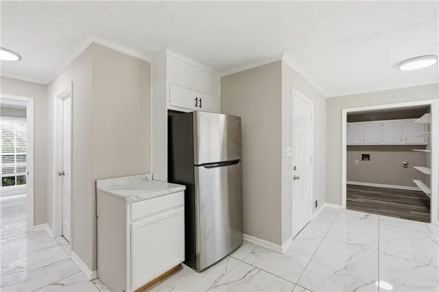 a room with a refrigerator and cabinets