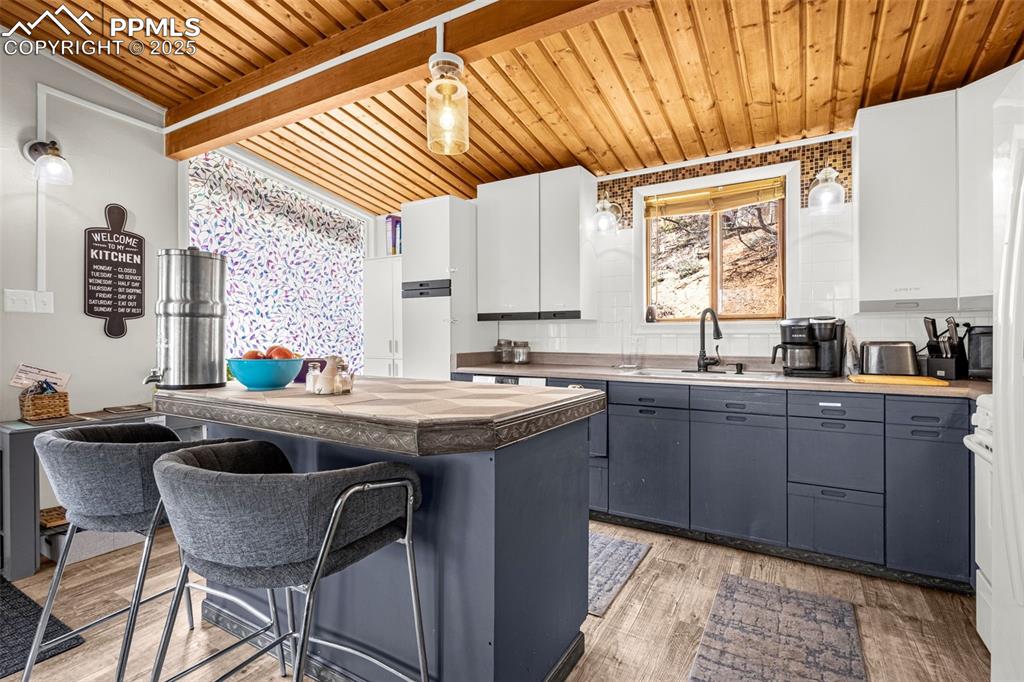 9515 Mountain Road Cascade, CO 80809 - Photo 16 of 34 a kitchen with granite countertop a sink and a stove