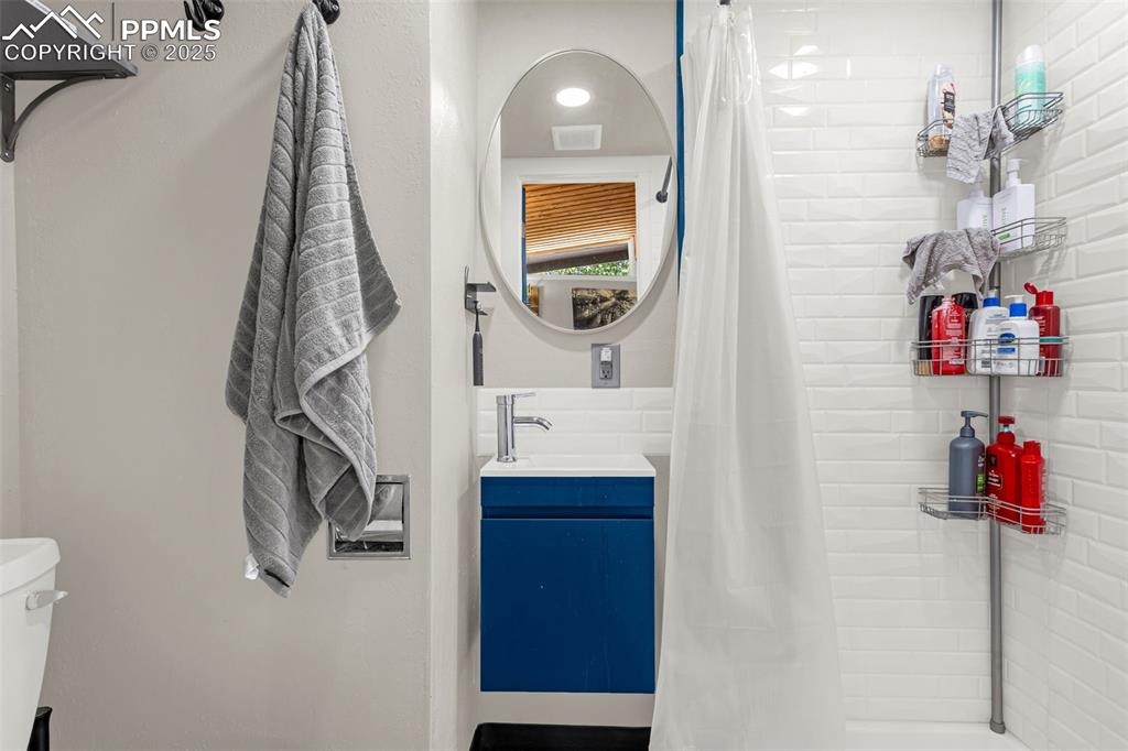 9515 Mountain Road Cascade, CO 80809 - Photo 23 of 34 a bathroom with a sink and a mirror