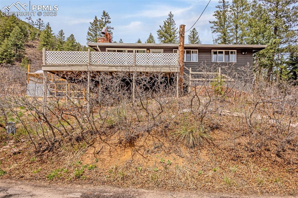 9515 Mountain Road Cascade, CO 80809 - Photo 27 of 34 a view of a house with a yard