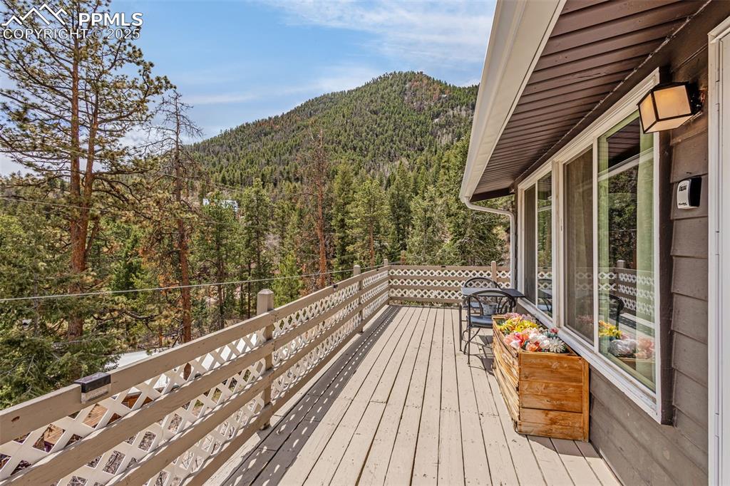 9515 Mountain Road Cascade, CO 80809 - Photo 9 of 34 a view of balcony with wooden floor and fence