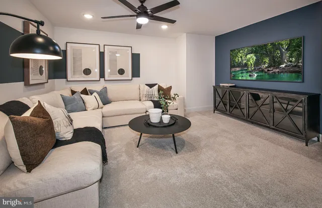 a living room with furniture a window and a flat screen tv