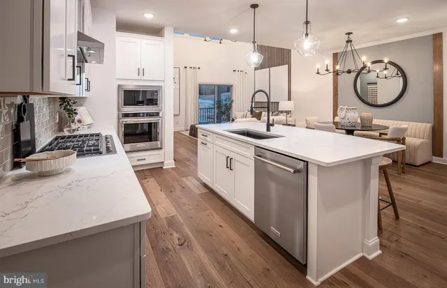 a large kitchen with stainless steel appliances kitchen island a large island a stove a refrigerator and a sink