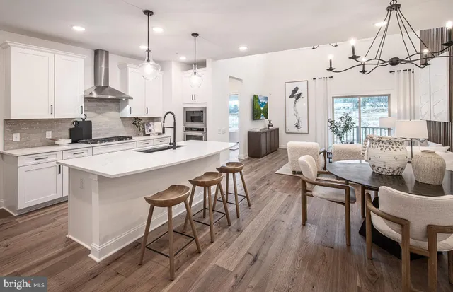 a large kitchen with a table and chairs