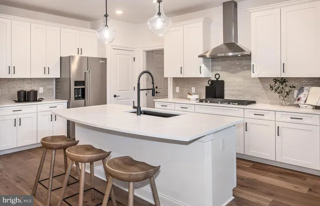 a kitchen with a white center island and appliances