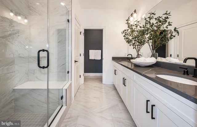 a bathroom with a double vanity sink and mirror