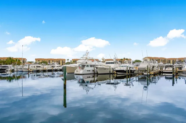 a view of a chairs and table in patio with a swimming pool