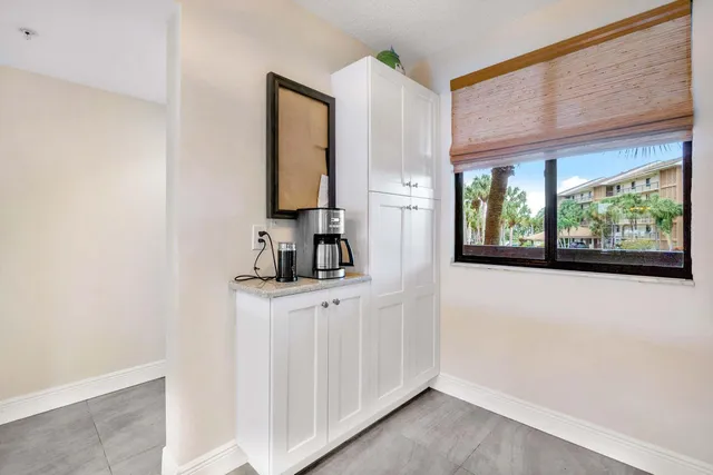 a kitchen with granite countertop a refrigerator stove and sink
