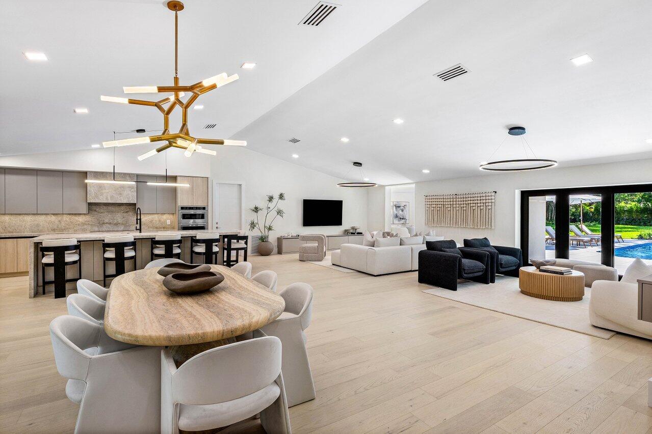 8090 Twin Lake Drive Boca Raton, FL 33496 - Photo 11 of 56 a living room with furniture a dining table and chairs