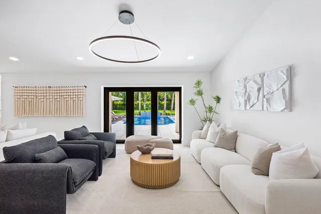a view of a patio with couches potted plants and a table