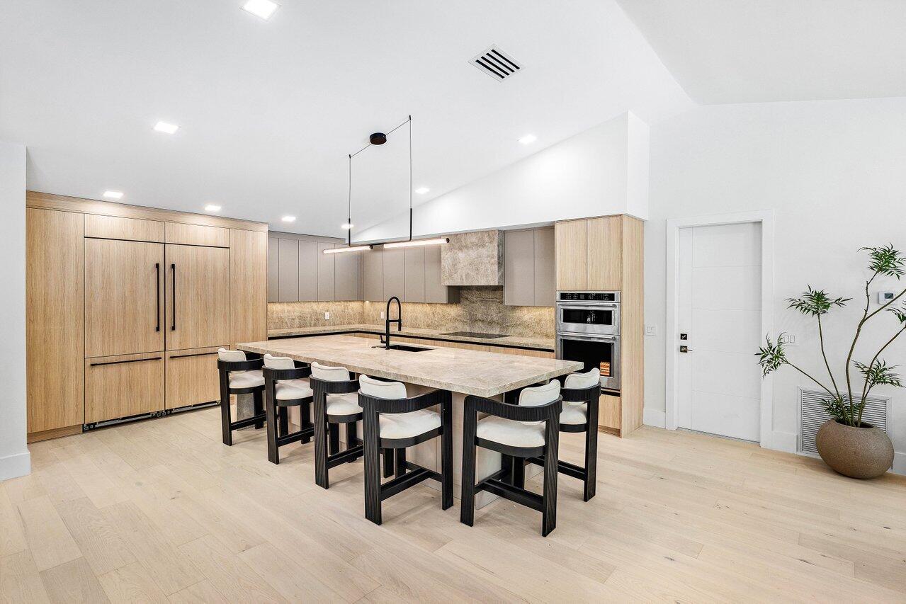 8090 Twin Lake Drive Boca Raton, FL 33496 - Photo 20 of 56 a kitchen with a table and chairs in it