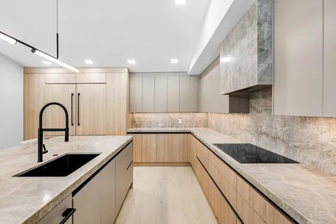 a view of a kitchen with kitchen island and wooden floor