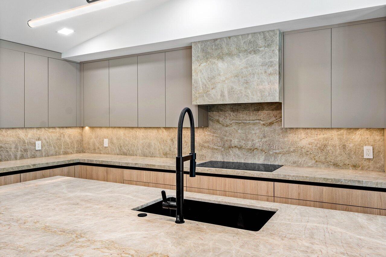 8090 Twin Lake Drive Boca Raton, FL 33496 - Photo 24 of 56 a view of a kitchen with kitchen island and wooden floor