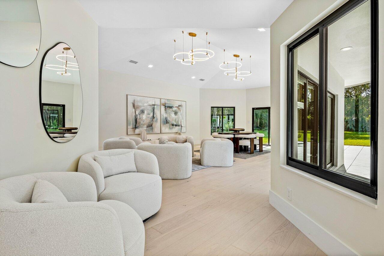 8090 Twin Lake Drive Boca Raton, FL 33496 - Photo 28 of 56 a living room with furniture fireplace and large windows