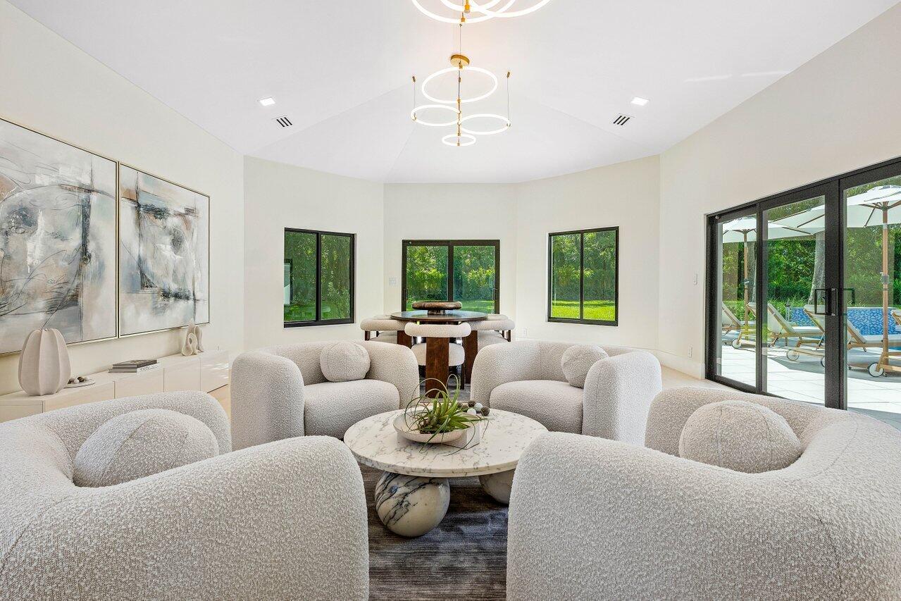 8090 Twin Lake Drive Boca Raton, FL 33496 - Photo 29 of 56 a living room with furniture and a large window