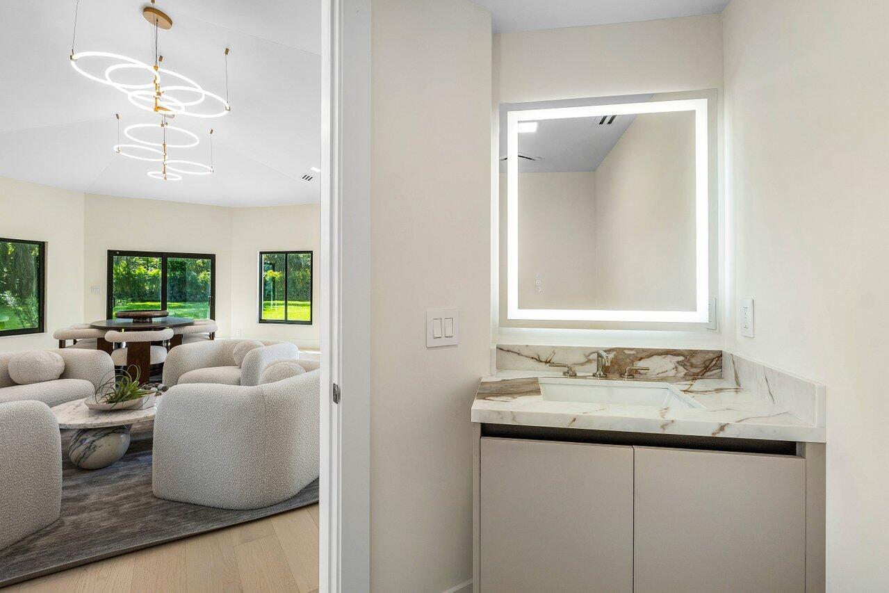 8090 Twin Lake Drive Boca Raton, FL 33496 - Photo 31 of 56 a en suite bathroom with a double vanity sink and a mirror