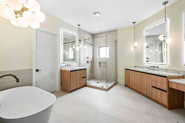 a kitchen with white cabinets and window