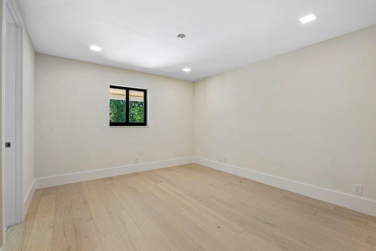 8090 Twin Lake Drive Boca Raton, FL 33496 - Photo 46 of 56 a view of an empty room with wooden floor and a window