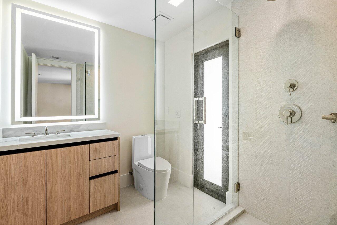 8090 Twin Lake Drive Boca Raton, FL 33496 - Photo 47 of 56 a bathroom with a sink a toilet and shower