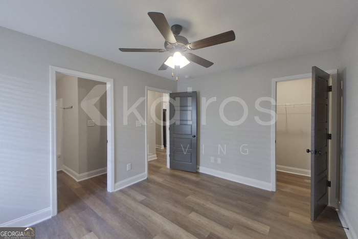 154 Allentown Way Macon, GA 31216 - Photo 11 of 21 a view of an empty room with wooden floor and a ceiling fan