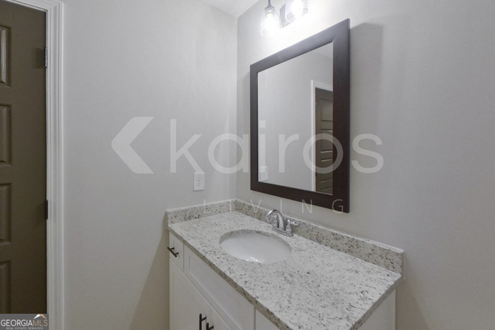 154 Allentown Way Macon, GA 31216 - Photo 17 of 21 a bathroom with a granite countertop sink and a mirror