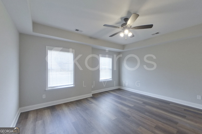154 Allentown Way Macon, GA 31216 - Photo 2 of 21 a view of an empty room with a window and wooden floor