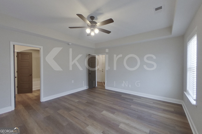 154 Allentown Way Macon, GA 31216 - Photo 3 of 21 a view of an empty room with wooden floor and a window