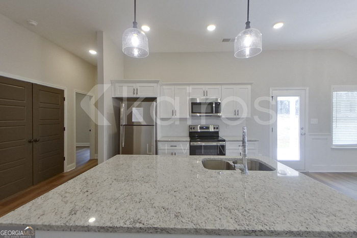 154 Allentown Way Macon, GA 31216 - Photo 6 of 21 a kitchen with stainless steel appliances kitchen island granite countertop a refrigerator a sink a stove and oven