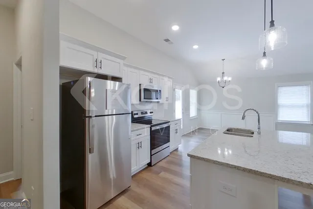 a kitchen with a stove and a microwave