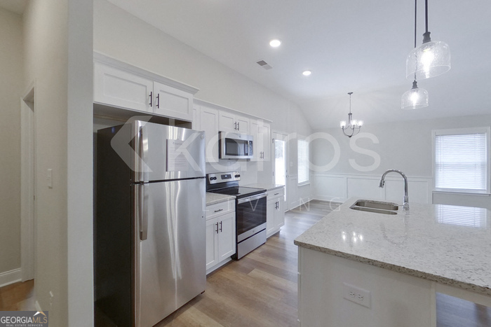 154 Allentown Way Macon, GA 31216 - Photo 7 of 21 a kitchen with kitchen island a sink appliances and cabinets