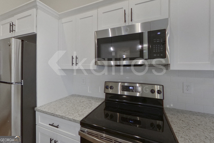 154 Allentown Way Macon, GA 31216 - Photo 8 of 21 a kitchen with a stove and a microwave