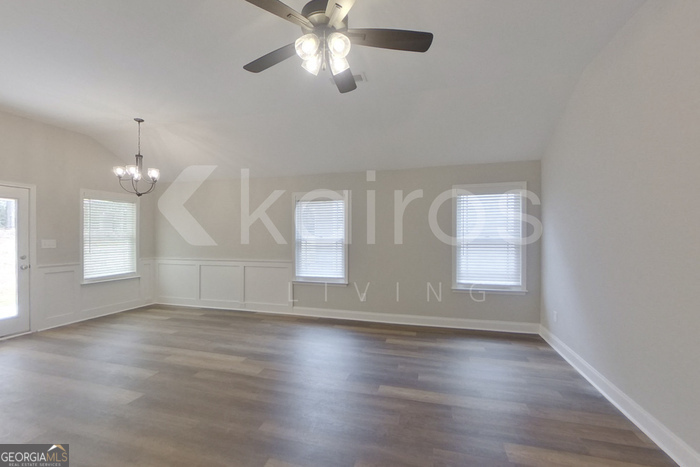 154 Allentown Way Macon, GA 31216 - Photo 9 of 21 an empty room with wooden floor fan and windows