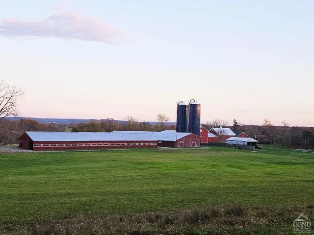 an empty room with windows and ceiling fan