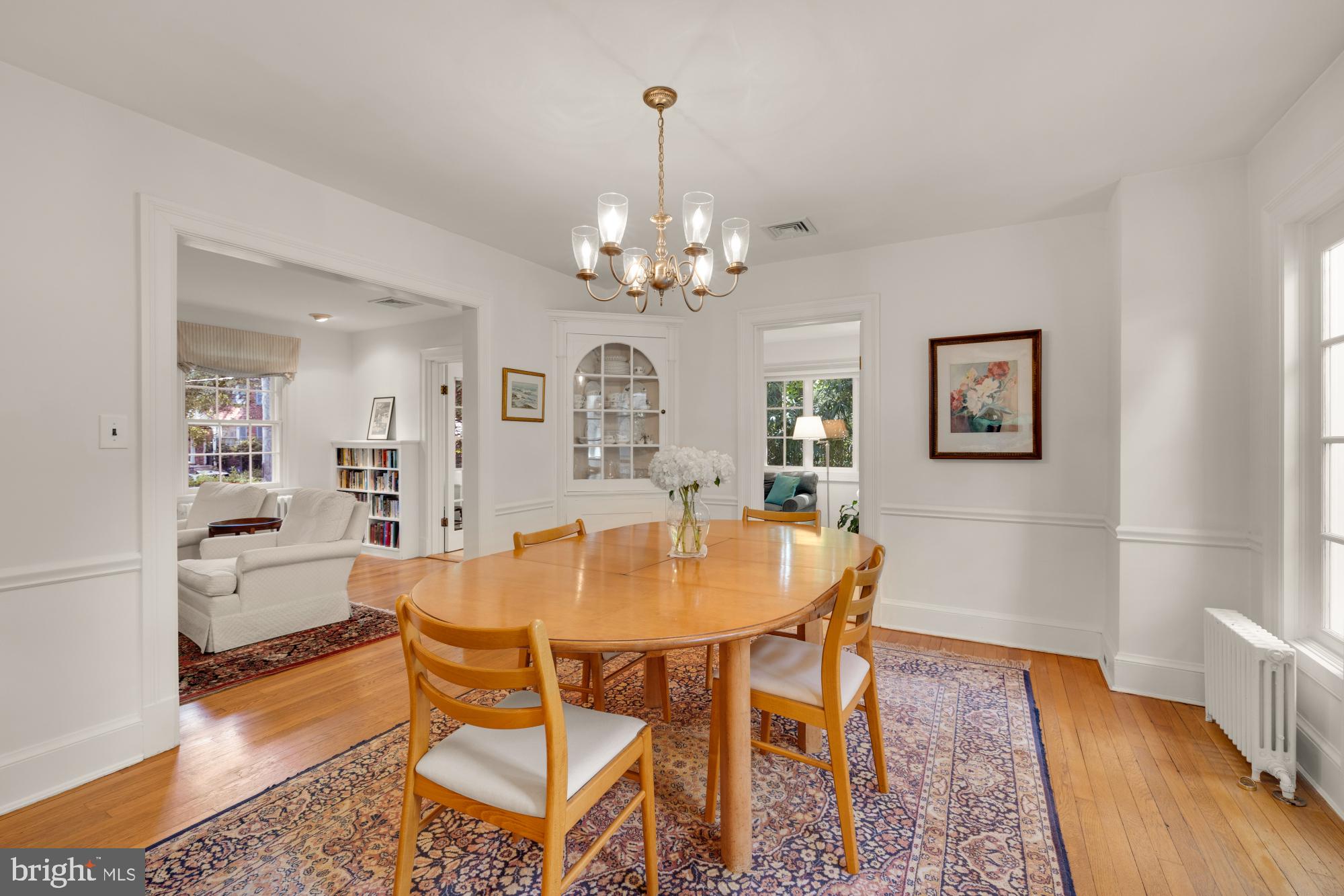 3514 Shepherd Street Chevy Chase, MD 20815 - Photo 14 of 42 a dining room with wooden floor a chandelier a wooden table and chairs