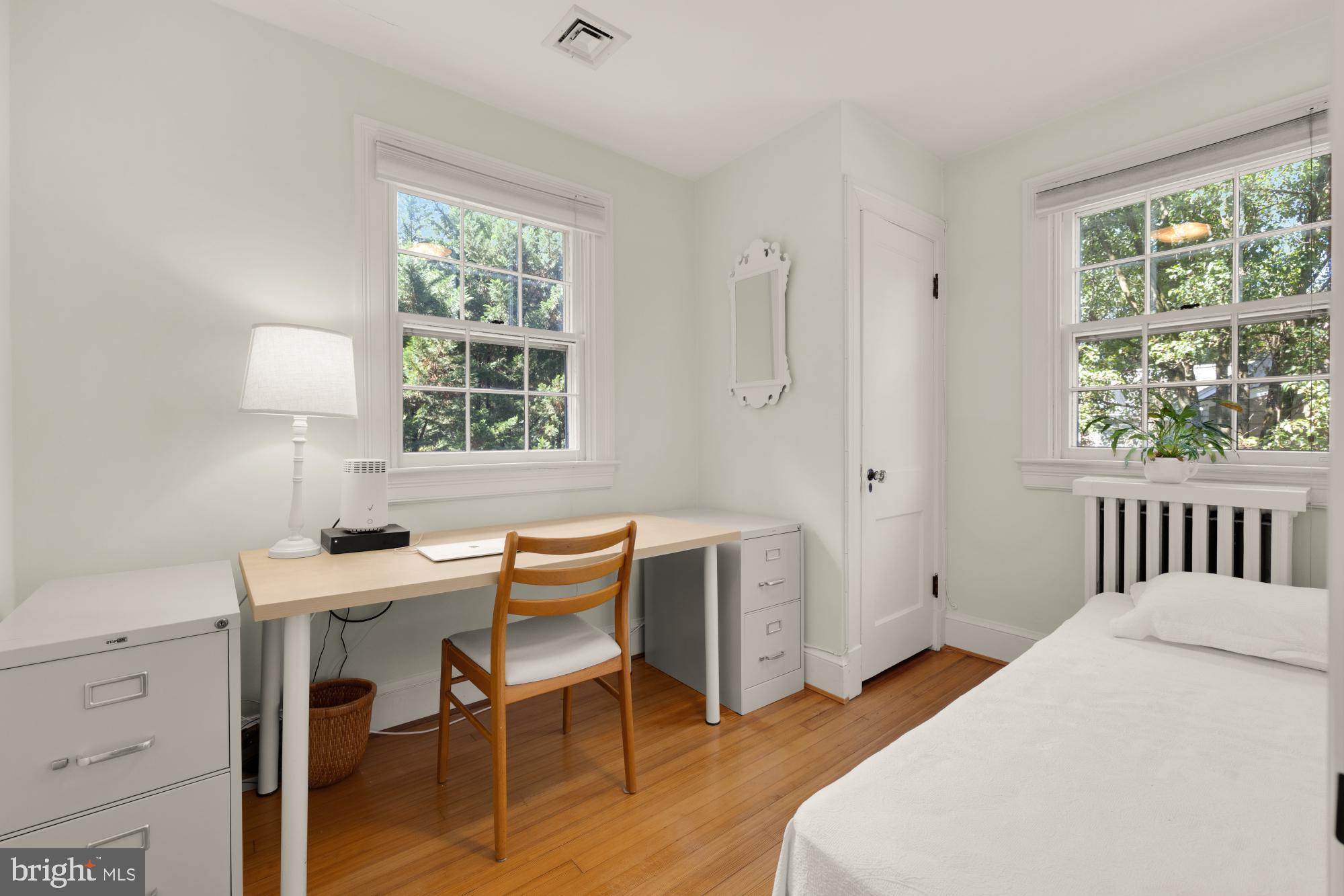 3514 Shepherd Street Chevy Chase, MD 20815 - Photo 29 of 42 a bedroom with a bed and a table in it